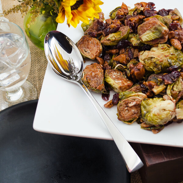 A plate of food with a Walco Freya stainless steel serving spoon.