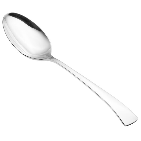 A close-up of a Walco Freya stainless steel serving spoon with a silver handle.