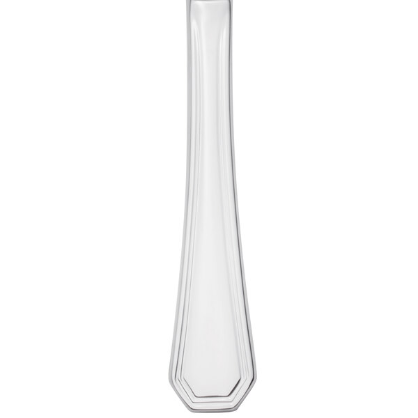 A Walco stainless steel table knife with a white background and black lines.