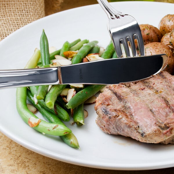 A plate of food with a knife and fork.