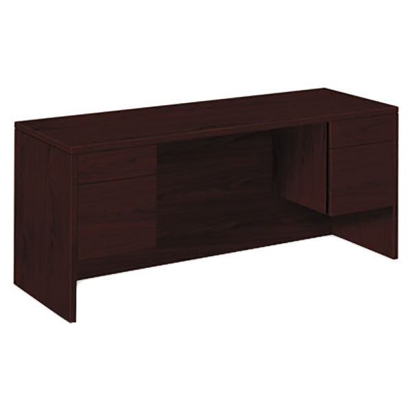 A dark brown HON pedestal credenza desk with drawers.