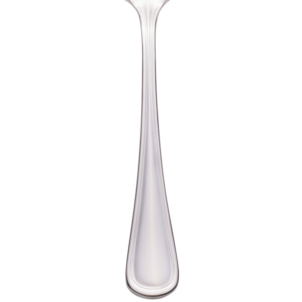 A Walco stainless steel serving spoon with a pierced bowl and a white handle.