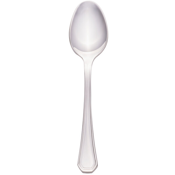 A silver Walco 18/10 stainless steel demitasse spoon with a white handle.