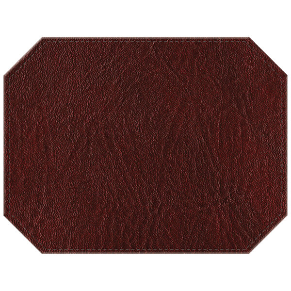 A white hardboard octagon placemat with brown faux leather and stitching in a wine design.