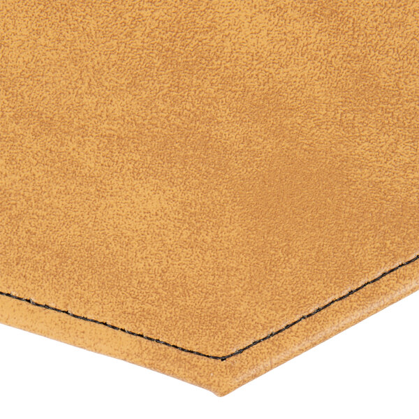 A close up of a customizable tan faux leather octagon placemat with a nugget design.