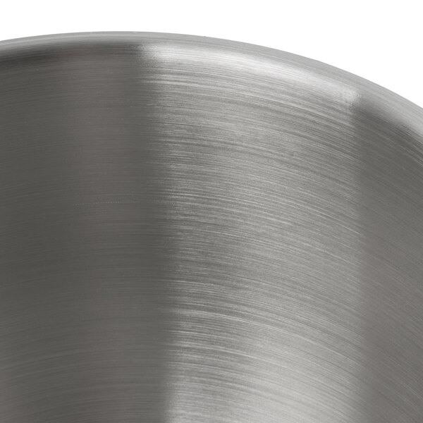 A close-up of a KitchenAid stainless steel mixing bowl with a brushed finish.