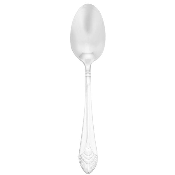 A close-up of a Walco stainless steel dessert spoon with a black background.
