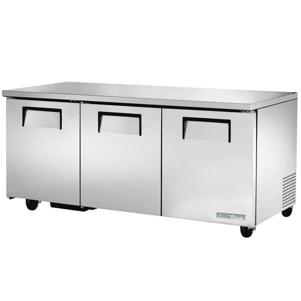 A stainless steel True undercounter refrigerator on wheels.