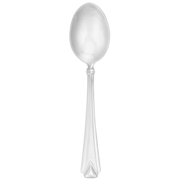 A Walco stainless steel demitasse spoon with a white handle.