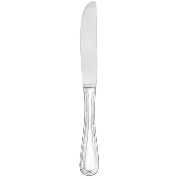 A silver Walco stainless steel butter knife with a white handle.