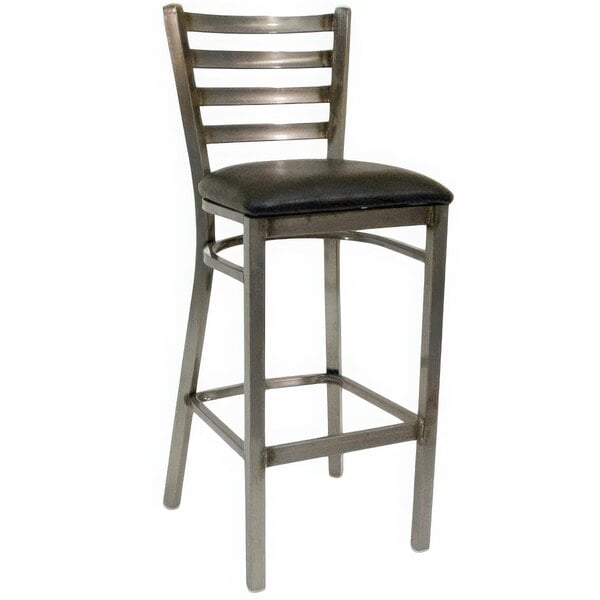 An American Tables & Seating metal barstool with a black vinyl cushion.