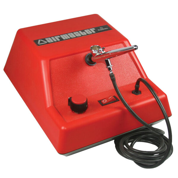 A red Kopykake airbrush compressor with a black cord.