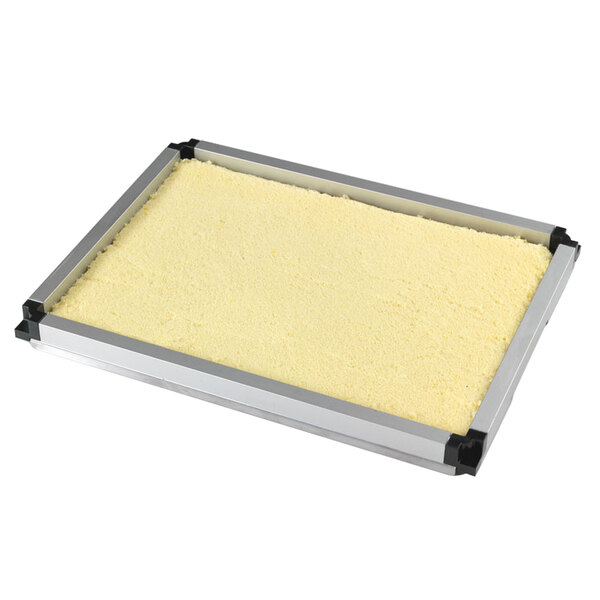 A rectangular metal tray with a white layer of cake using a Matfer Bourgeat red mousse frame.