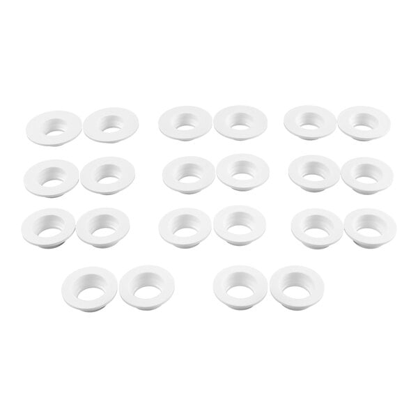 A group of white, round, flat washers or grommets arranged in a grid pattern on a white background.