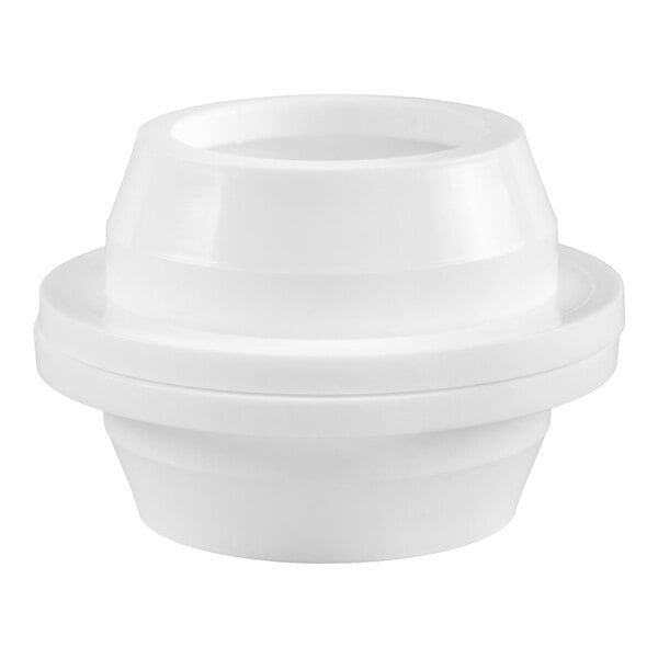 A white, round, plastic object with a tiered design and a central opening, resembling a lid or container component.