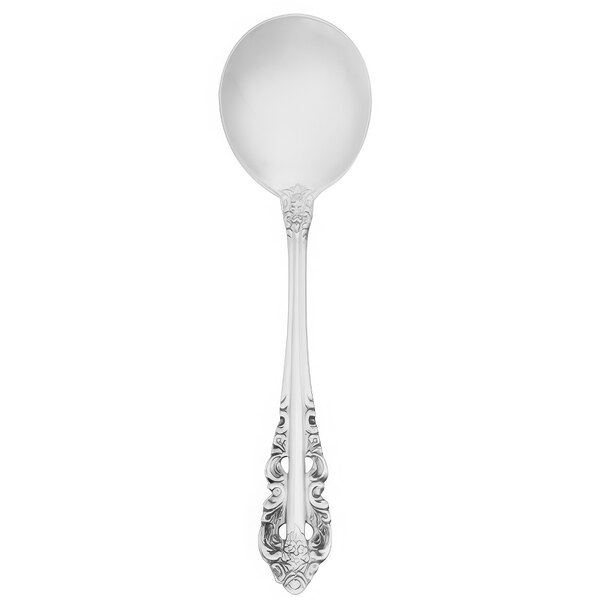 A silver Walco Classic Baroque bouillon spoon with a patterned handle.