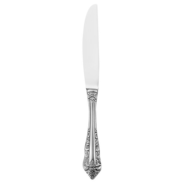 A silver Walco European table knife with a white handle.