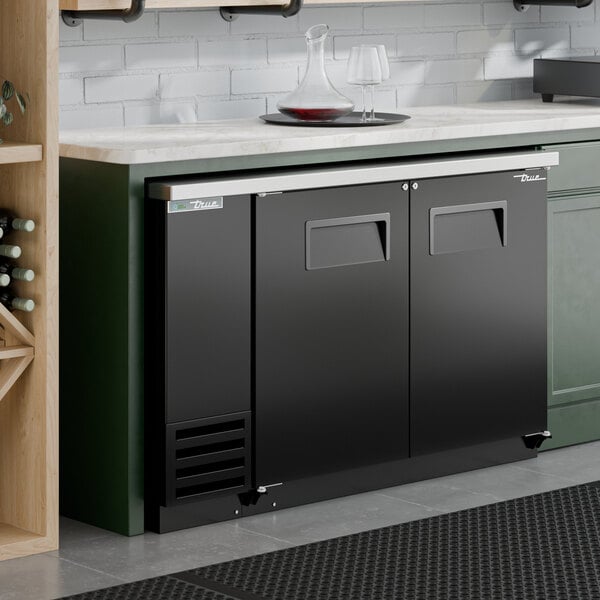 A black solid door back bar refrigerator with LED lighting, designed for undercounter installation.