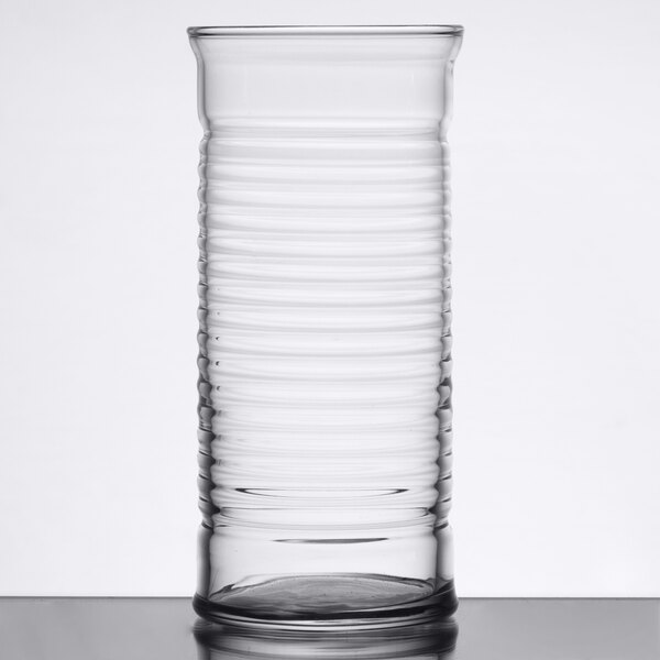 An Arcoroc highball glass on a table.