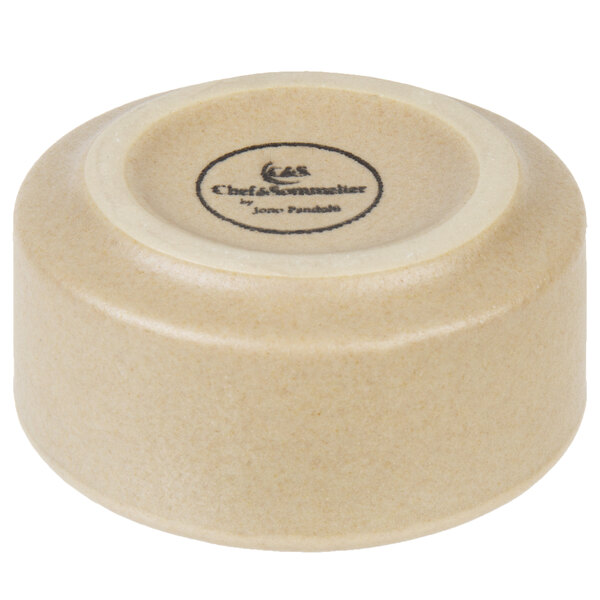 A close up of a black Chef & Sommelier stackable stoneware ramekin.