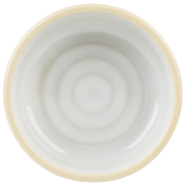 A white stackable bowl with a yellow rim.
