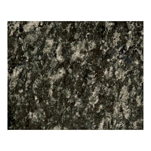 A close up of a black and white speckled Uba Tuba granite table top.