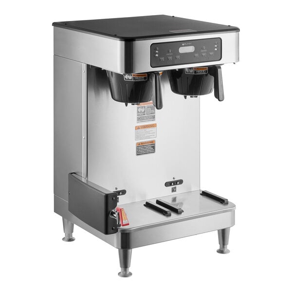 A silver stainless steel Bunn commercial coffee machine with two coffee pots on top.