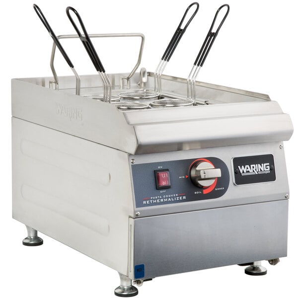 A large stainless steel Waring electric pasta cooker on a counter.