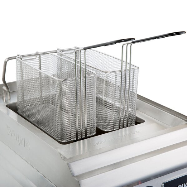 A close-up of a Waring electric pasta cooker on a counter.