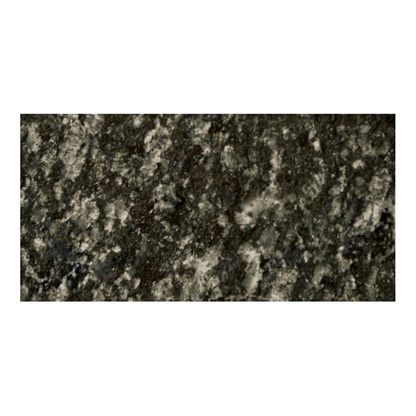 A close-up of an Uba Tuba granite table top with black and white speckles.