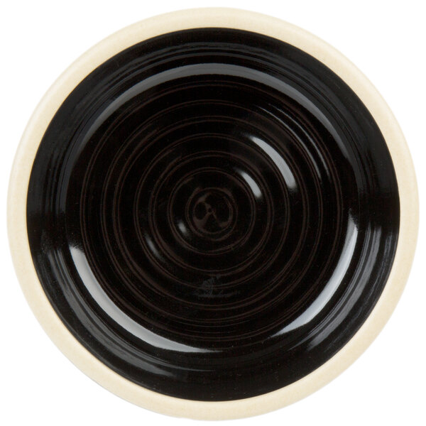 A black stoneware bowl with a white rim.