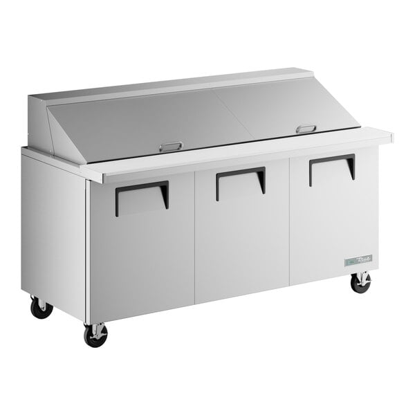 A True stainless steel 3 door refrigerated sandwich prep table.