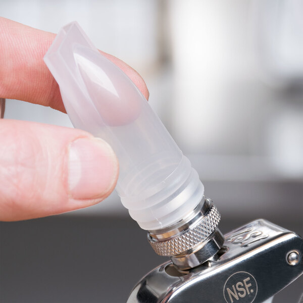 A person holding a plastic tube with a clear cap on the end.