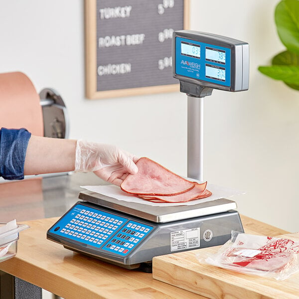 A person wearing a plastic glove weighing meat on an AvaWeigh digital price computing scale.