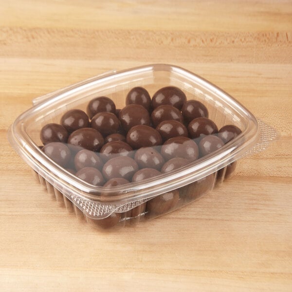 Plastic container holding round pieces of chocolate