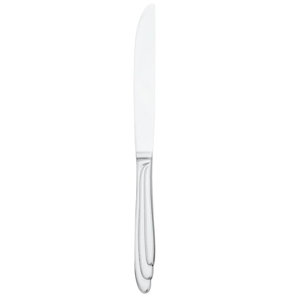 A Walco stainless steel European table knife with a white handle and silver blade.