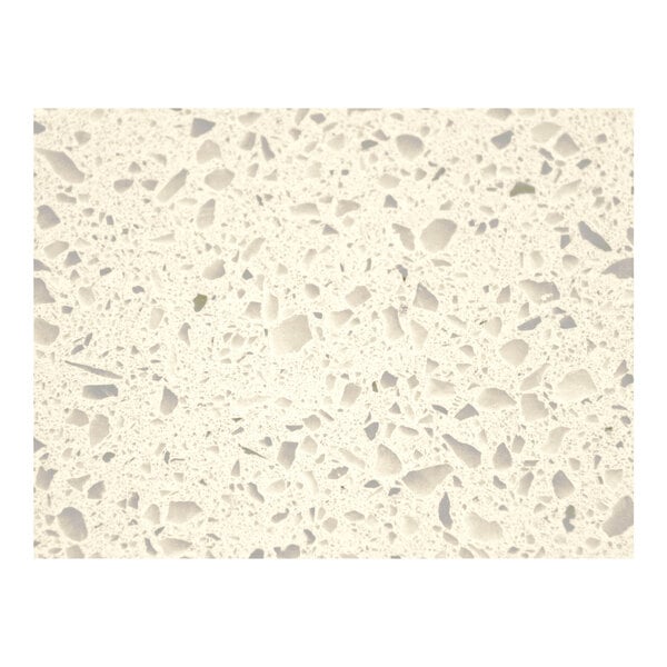 A close-up of an Art Marble Furniture Snow White Quartz Tabletop with small gray and white speckles.