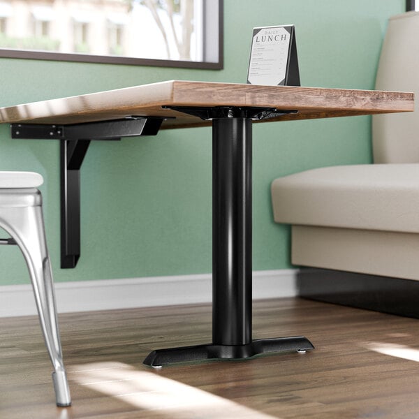 A close up of a Lancaster Table & Seating black end column table base leg.