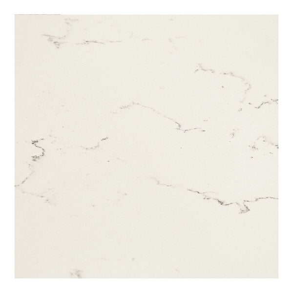 A close up of an Art Marble Furniture Carrera White Quartz Tabletop with black spots.