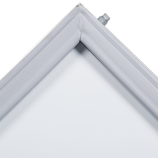 A close up of a white reversible door with a metal frame.