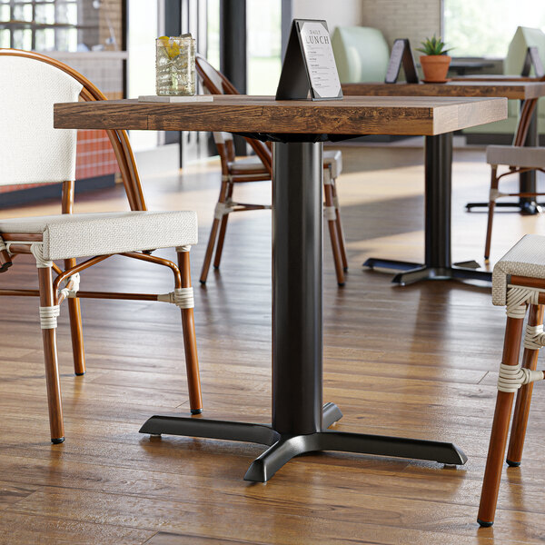 A Lancaster Table with a black cast iron column base on it.