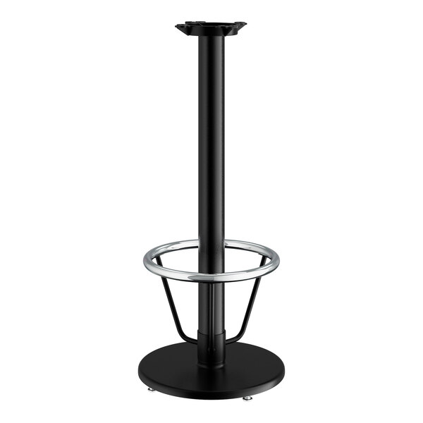 A Lancaster Table & Seating black cast iron bar height table base with a round foot ring.