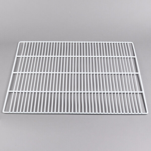 A white metal grate on a gray surface.