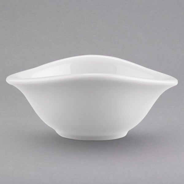 A close-up of a Villeroy & Boch white porcelain bowl with a curved edge.