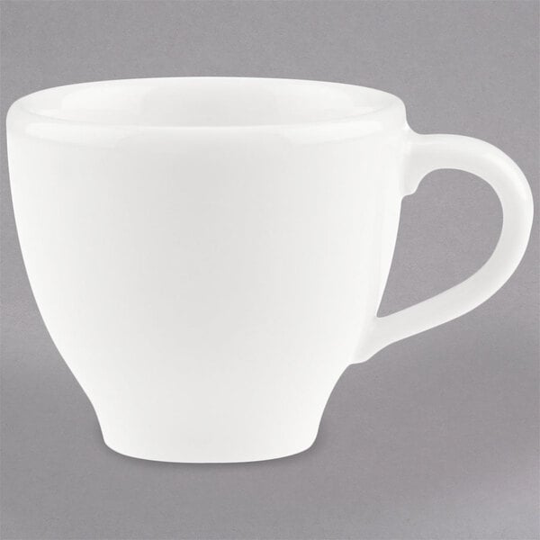 A close-up of a Villeroy & Boch white porcelain cup with a handle.