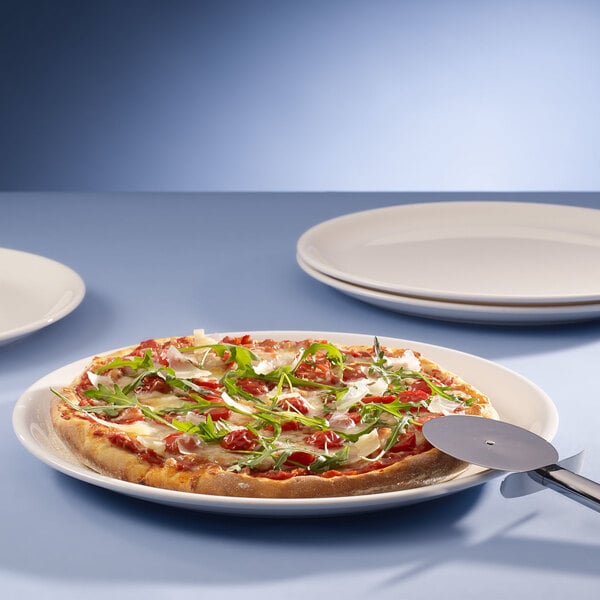 A pizza on a Villeroy & Boch white porcelain plate.