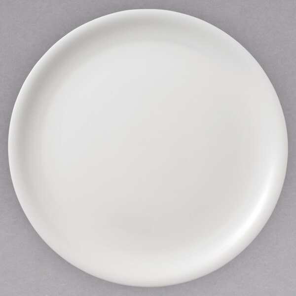 A white Villeroy & Boch porcelain plate with a white rim on a gray surface.