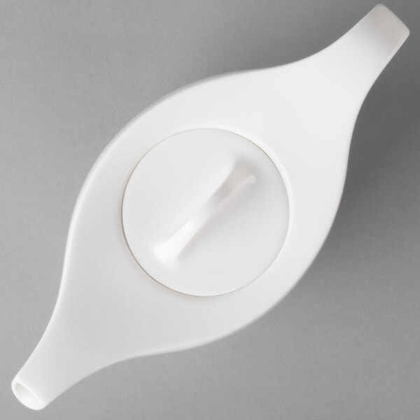 A close-up of a white Villeroy & Boch porcelain teapot with a lid and a handle.