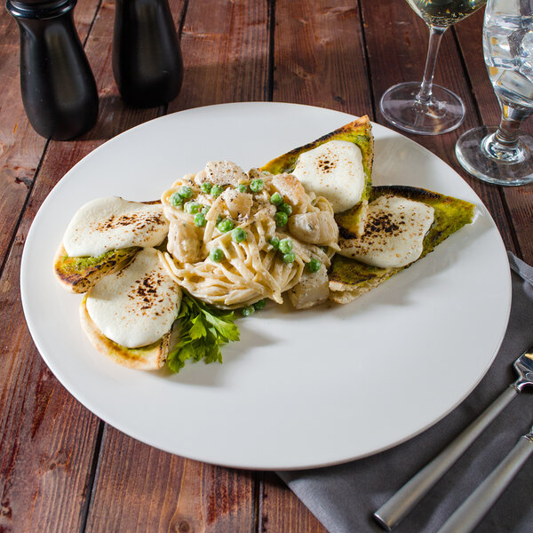 A Villeroy & Boch white porcelain plate with food on a table.