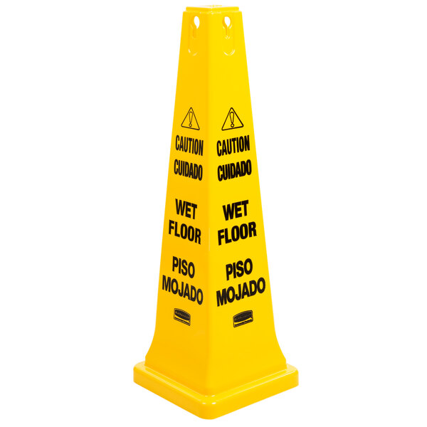 A yellow Rubbermaid caution cone with black and yellow text reading "Caution Wet Floor" in English and Spanish.